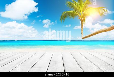 Coconut palm trees against blue sky and beautiful beach in Punta Cana, Dominican Republic. Vacation holidays background wallpaper. View of nice tropic Stock Photo