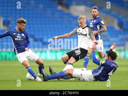 Derby County's Louie Sibley (centre) battles for the ball with Cardiff City's Joe Bennett (left) and Sean Morrison battle for the ball during the Sky Bet Championship match at the Cardiff City Stadium. Stock Photo