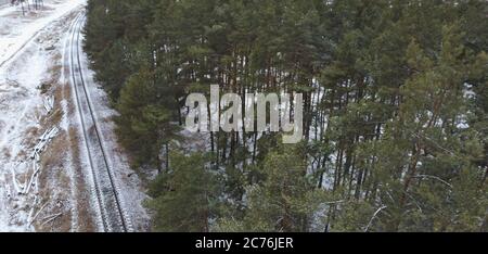 Top view rail road. Winter snow forest railway landscape. Forest railroad in winter snow scene. Stock Photo