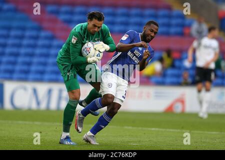 Cardiff, UK. 14th July, 2020. Junior Hoilett of Cardiff City (r) collides with Derby county goalkeeper Kelle Roos. EFL Skybet championship match, Cardiff city v Derby County at the Cardiff City Stadium in Cardiff, Wales on Tuesday 14th July 2020. this image may only be used for Editorial purposes. Editorial use only, license required for commercial use. No use in betting, games or a single club/league/player publications. pic by Andrew Orchard/Andrew Orchard sports photography/Alamy Live news Credit: Andrew Orchard sports photography/Alamy Live News Stock Photo