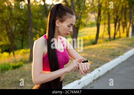 Woman checking fitness and health tracking wearable device Stock Photo