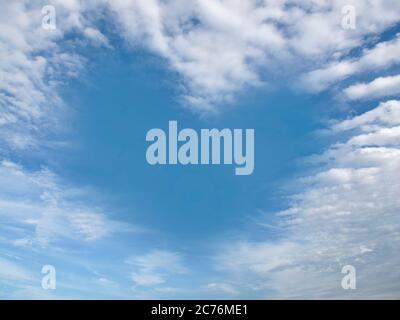 Heart-shaped cloud on clear blue sky during the day. Romantic love concept