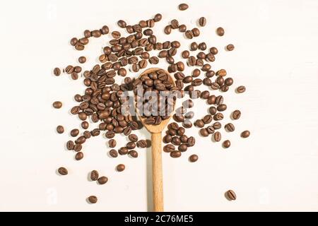 coffee beans and wooden spoon isolated on white background Stock Photo