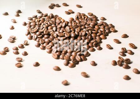 coffee beans arranged in the shape of a heart isolated on white background Stock Photo