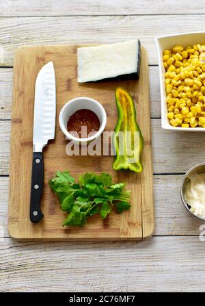 Organic whole ingredients ready for preparing gourmet Mexican Street Corn Salad for Cinqo de Mayo family celebration party using fresh healthy foods Stock Photo