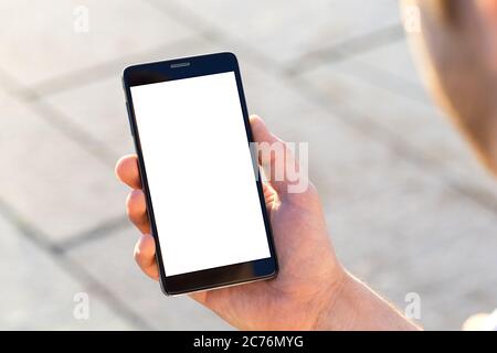 Man uses his Mobile Phone outdoor, close up Stock Photo