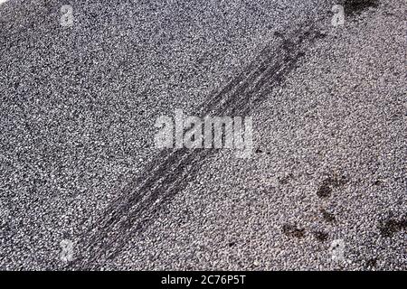 Tire tracks on a asphalt road, abstract background Stock Photo