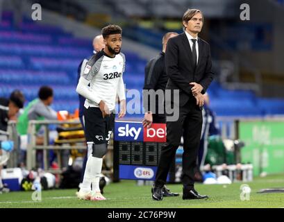 Derby County's Jayden Bogle (left) and manager Phillip Cocu during the Sky Bet Championship match at the Cardiff City Stadium. Stock Photo