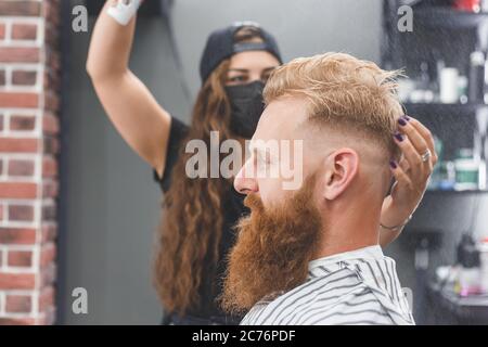 Hair styling in women barbershop. Spray Stock Photo