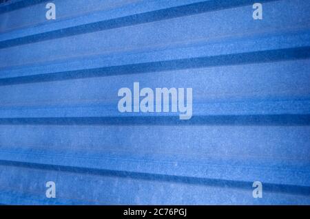 Metal construction, blue profiled material  for coating roof house or fence. Construction industry. Foto perspective. Stock Photo