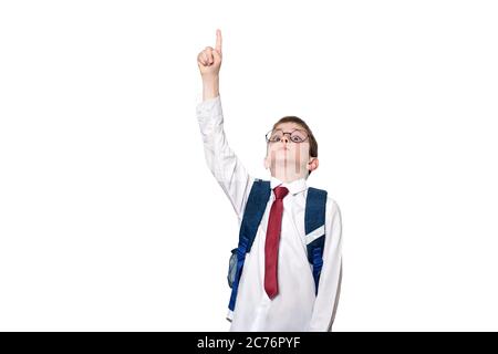 Boy with a backpack and in round glasses points his finger up. School concept. Isolate Stock Photo