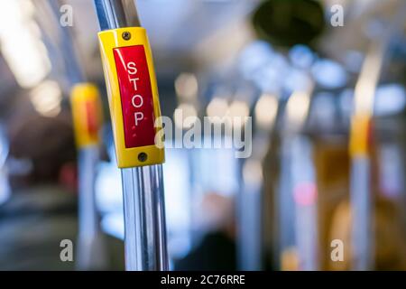 Bright red Stop button inside a bus Stock Photo