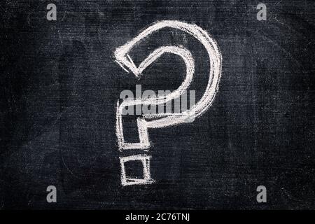 Question mark on school blackboard, questioning symbol written in chalk Stock Photo