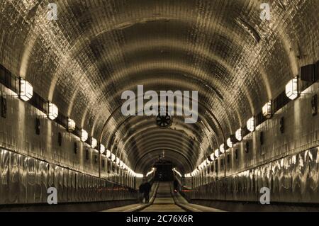 Alter Elbtunnel in Hamburg - old tunnel under river Elbe - centered, people Stock Photo