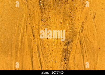 Close-up of sand with tidal ways and shells on the beach, full frame texture Stock Photo