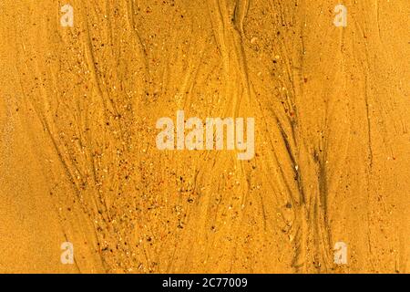 Close-up of sand with tidal ways and shells on the beach, full frame texture Stock Photo