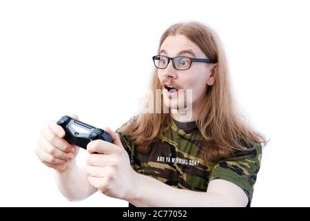 Happy Long Haired Gamer Playing Console Video Game Holding Controller Stock Photo