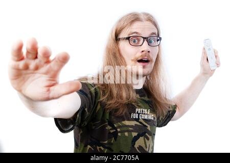 Long Haired Gamer Swinging Video Game Controller Stock Photo