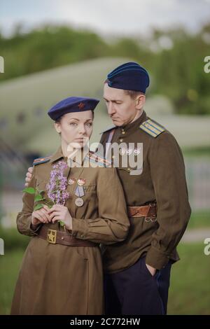 Young adult man and woman in the uniform of pilots of the Soviet Army of the period of World War II. Military uniform with shoulder straps of a major Stock Photo