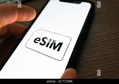 eSIM card chip logo on the smartphone screen.  Stock Photo