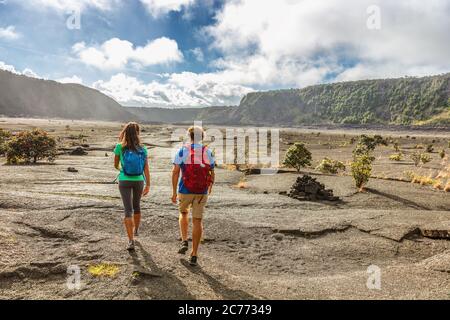 Couple tourists hikers walking on Kilauea Iki crater trail hike in Big Island, Hawaii. USA summer travel vacation destination for outdoor nature Stock Photo