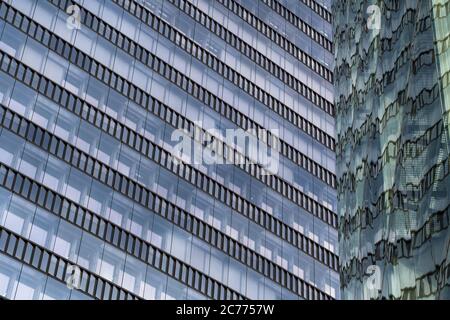 Glass Facade Of Modern Office Buildings With Reflections Of Neighboring Towers In The City Of Vienna Stock Photo