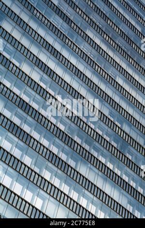 Glass Facade Of Modern Office Buildings With Reflections Of Neighboring Towers In The City Of Vienna Stock Photo