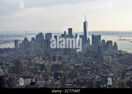 The downtown skyline of New York City taken from the Empire State Building.  One World Trade Centre, Statue of Liberty & Verrazano Bridge are visible. Stock Photo