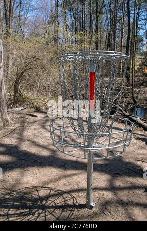 metal disc golf cage in spring woods Stock Photo