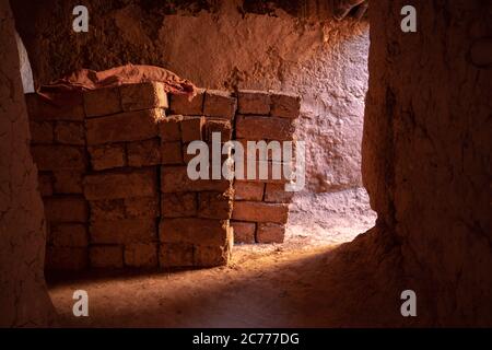 Bricks stacked in old cave Stock Photo