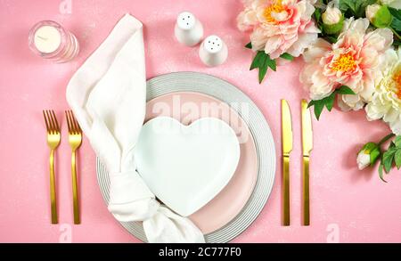 Pink aesthetic elegant fine china events table place setting overhead for weddings, birthday, Christmas, Thanksgiving or Valentine's Day celebrations. Stock Photo