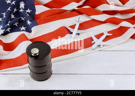 Model airplane on rising world fuel tank oil barrel prices brand USA flag Stock Photo