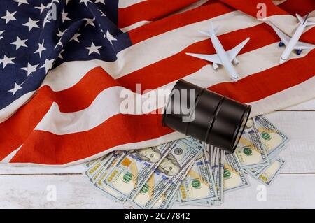 Oil barrels on US dollar oil business, rising world oil prices brand USA flag model airplane Stock Photo