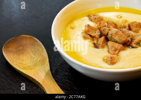 Pea puree with fried meat on a dark background Stock Photo