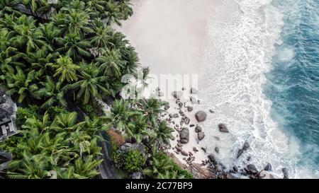 Seychelles beach Indian ocean from drone, shore and mountains.  Stock Photo