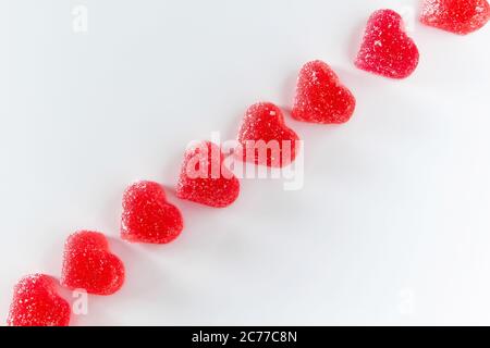 Diagonal of red marmalade in the shape of a heart. Place for your text. Stock Photo