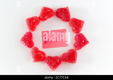 Circle made of sweet red marmalade in the shape of a heart and the word love. Stock Photo