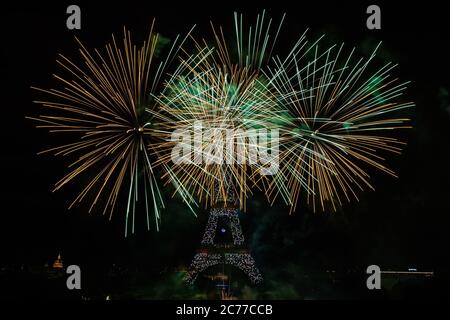 Paris, France. 14th July, 2020. Fireworks explode near the Eiffel Tower during the Bastille Day celebrations in Paris, France, July 14, 2020. Credit: Aurelien Morissard/Xinhua/Alamy Live News Stock Photo