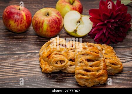 Home baked puff pastry on a background of apples and flowers Stock Photo