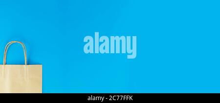 Half paper shopping bag isolated on blue background  with copy space Stock Photo