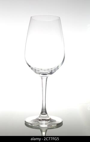 Empty wine glass on glass table. Empty glass on white background. Stock Photo