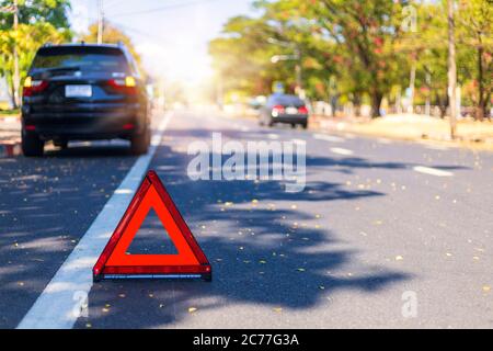 Red triangle, red emergency stop sign, red emergency symbol with  car stop and park on road. Stock Photo