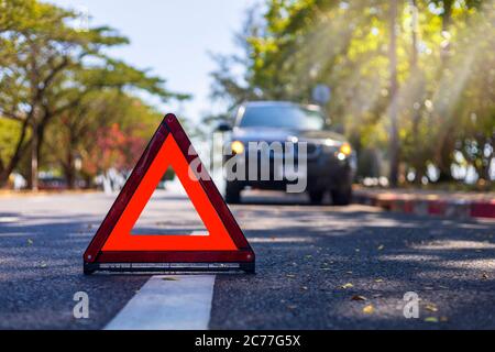 Red triangle, red emergency stop sign, red emergency symbol with  car stop and park on road. Stock Photo