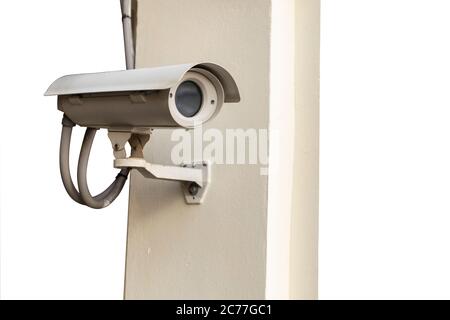 CCTV camera on wall isolated on white background. Stock Photo