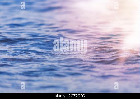 Sea wave close up with low angle view sunrsie shot. Background texture for text or design. Stock Photo