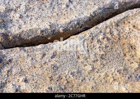 Big rock on beach with cracks background. For text or design. Stock Photo