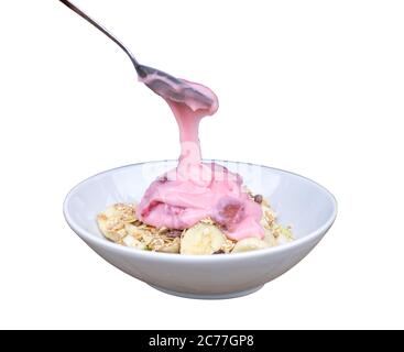 Pour  yogurt strawberry from spoon to bowl and in bowl have banana slide , guava. Isolate on white background. Save with cliping path. Stock Photo