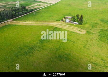 aerial view over the agricultural farm among green fields. summer countryside landscape Stock Photo