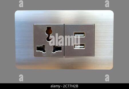 Electric wall plug socket and USB charging port isolate on gray bakcground. Stock Photo