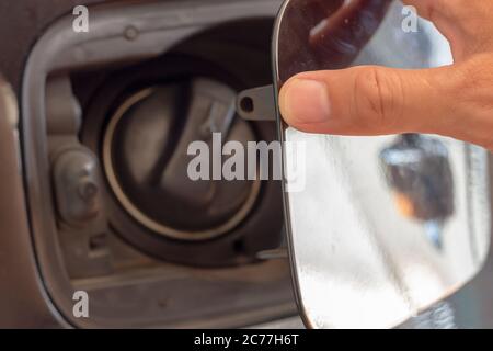 Close up hand man open the fuel tank cover in the car Stock Photo